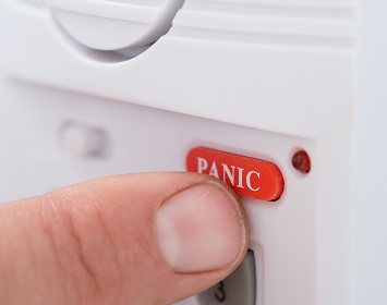 Close-up Of Person's Hand Pressing Panic Button