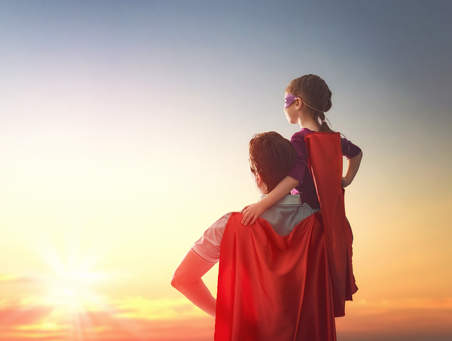 Happy loving family. Father and his daughter child girl playing outdoors. Daddy and his child girl in an Superhero's costumes. Concept of Father's day.