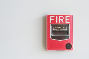 A fire alarm pull box on a wall.