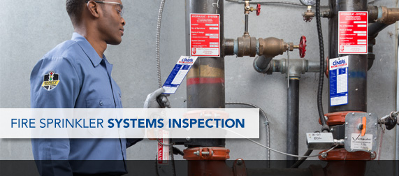 A fire professional inspects a fire sprinkler system