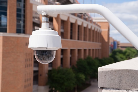 Video Security Camera Housing Mounted High On College Campus