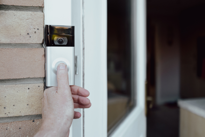 A proud homeowner tests his Ring® doorbell installed by Security Alarm.