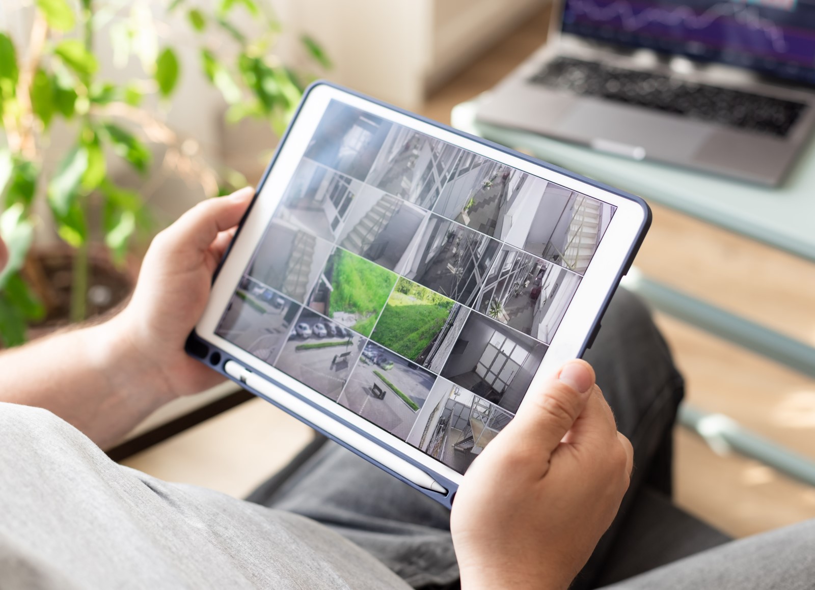 a man views camera footage of his business video surveillance system remotely from a personal device