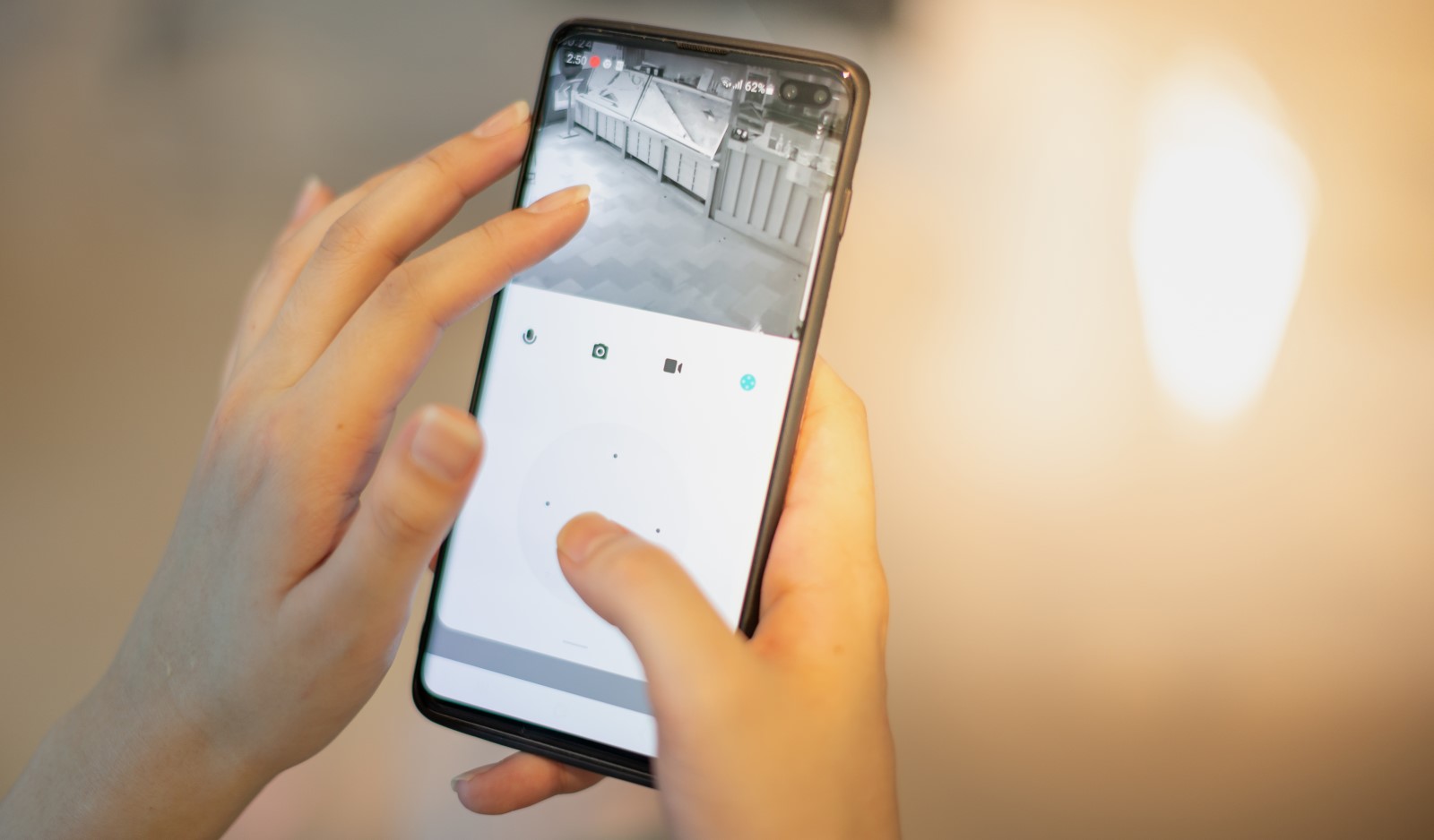 a restaurant owner checks her security system footage via her smartphone