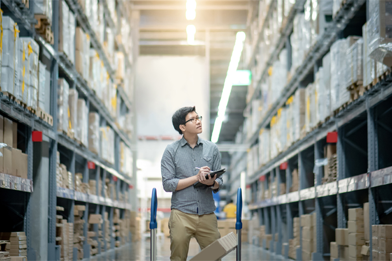 Worker inside a storage unit that is protected by a business security system.