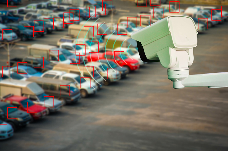 school security solutions like surveillance cameras keep a watchful eye on large areas like parking lots