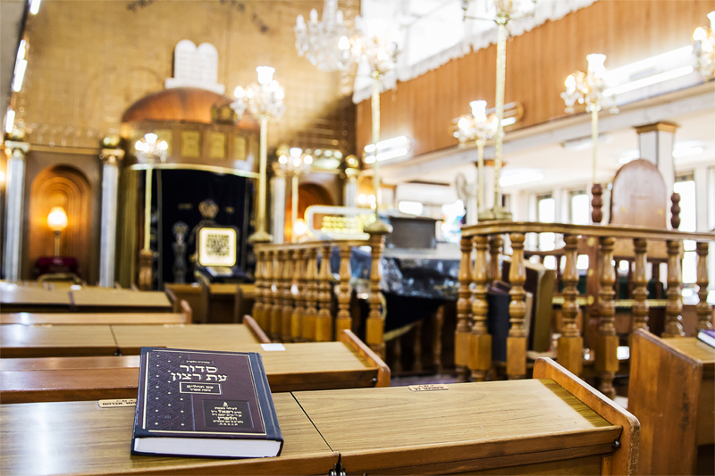 Interior of a synagogue with book in foreground.