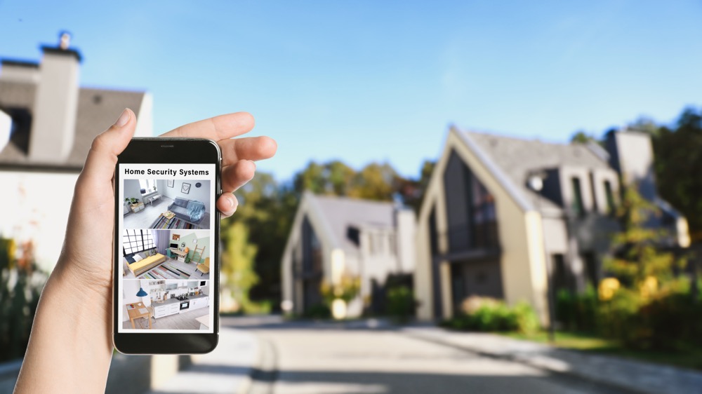 A woman remotely monitors her wireless home security system with cameras