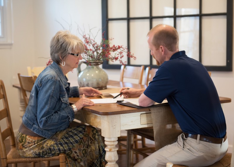 A Security Alarm customer has an in-home consultation with a technician.